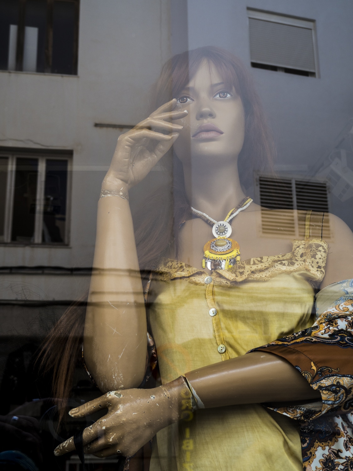 Mannequin with damaged hand and reflected architecture, Ibiza