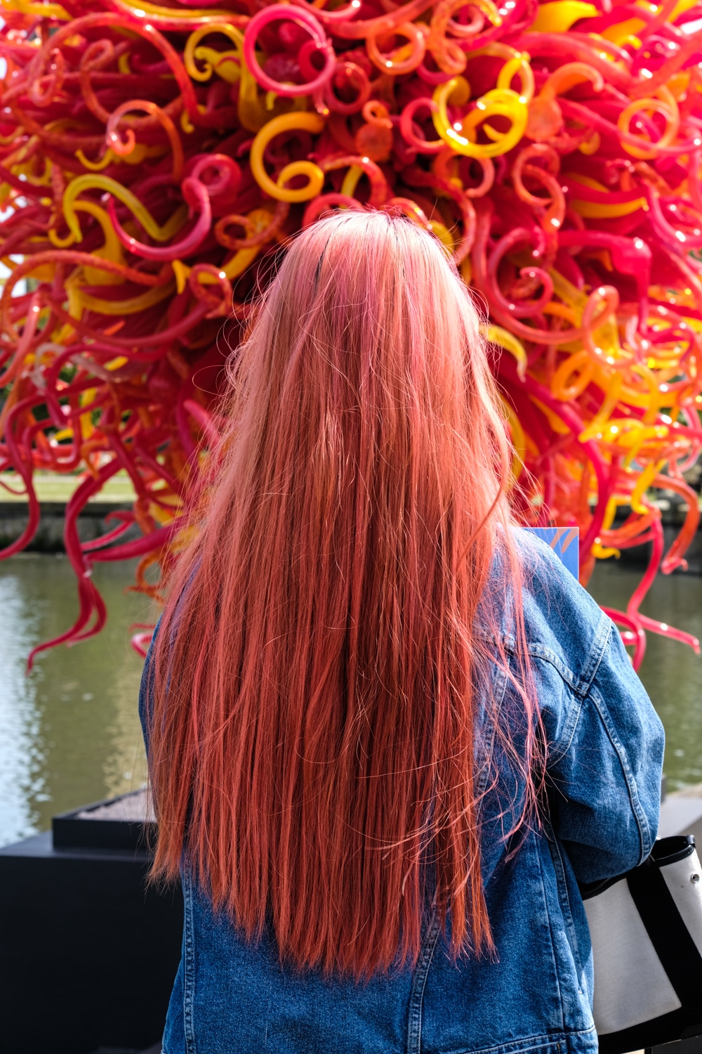 Chihuly glass sculpture Kew Gardens and girl with coral hair